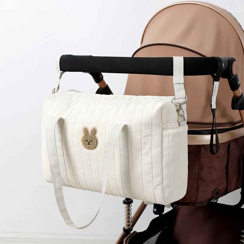 Sac à langer pratique pour bébé, sac en coton gaufré élégant, idéal pour les sorties avec bébé.