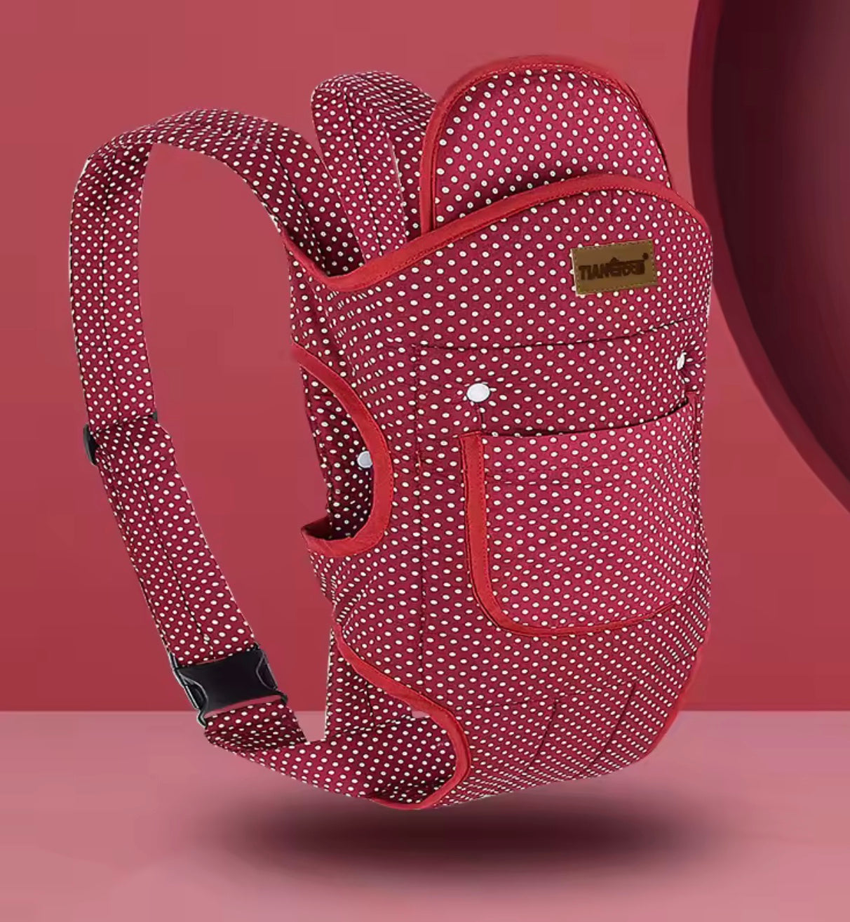 porte bébé de couleur rouge et blanc physiologique